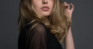 A high-end luxury fashion model showcasing 2026 style trends on a cinematic urban background with futuristic designer clothing.