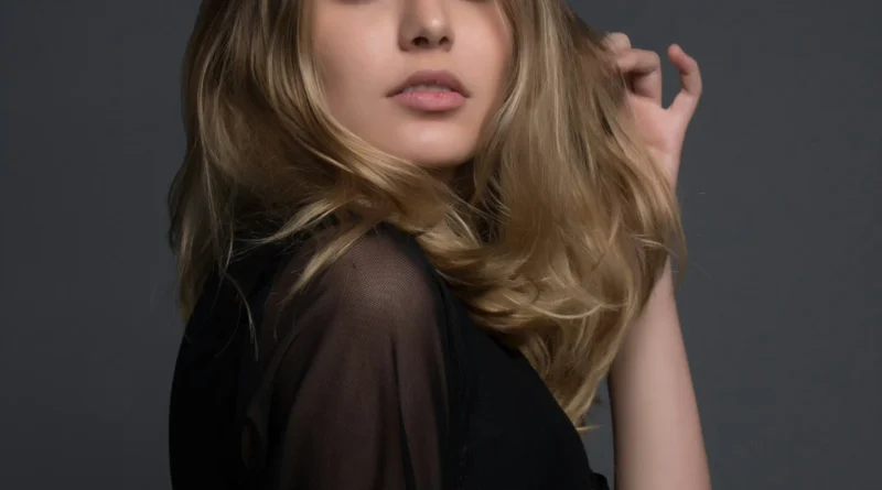 A high-end luxury fashion model showcasing 2026 style trends on a cinematic urban background with futuristic designer clothing.